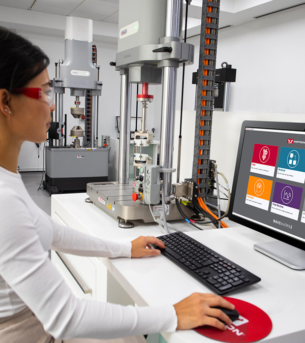 Operator using WaveMatrix software to control an ElectroPuls dynamic and fatigue testing system. | Instron