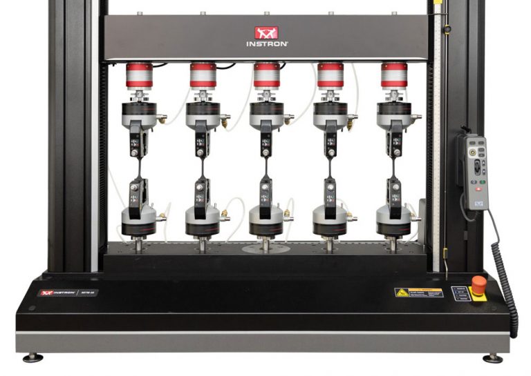 Instron 68TM-30 table model universal testing system configured with five parallel test stations and pneumatic grips for high-throughput testing.
